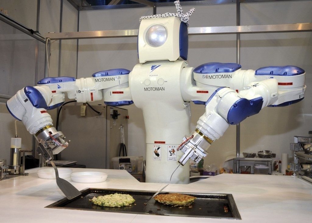 JAPAN - NOVEMBER 25: Robot Show In Tokyo, Japan On November 25, 2009 - A cooking robot named 'MOTOMAN' producted by Toyo Riki Engineering Co., Ltd - makes pancakes during International Robot Exhibition 2009, at Tokyo Big Sight. (Photo by Katsumi KASAHARA/Gamma-Rapho via Getty Images)