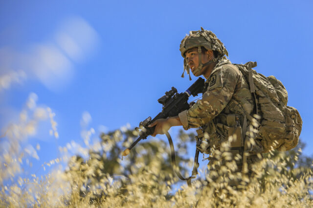 Alaska National Guard Pfc. Jericho Galleto, an infantryman assigned to Alpha Company, 1st Battalion, 297th Infantry Regiment, 29th Infantry Brigade Combat Team out of Alaska maneuvers to the end objective in a corridor platoon patrol and maneuvers training during an Exportable Combat Training Capability (XCTC) program at Camp Roberts, California, July 20, 2022. XCTC is a series of training exercises between an active-duty U.S. Army Brigade and an Army National Guard Brigade, intended to increase the skills and readiness of National Guard units. (U.S. Army National Guard photo by Sgt. Lianne M. Hirano)